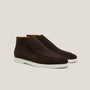 Pair of brown suede shoes on a light gray background
