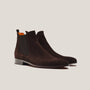 Pair of brown suede Chelsea boots on a light gray background