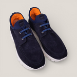 paired together view of a pair of navy suede laced design slip on sneakers with orange inner accents and a white sole